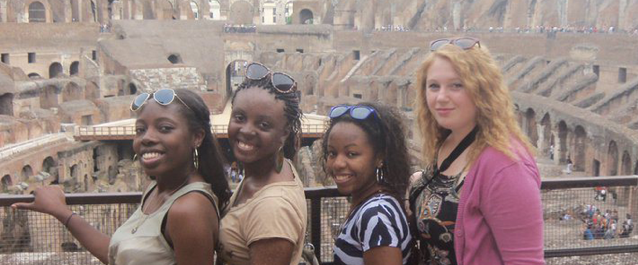 Erica with study abroad friends posing at the Coliseum