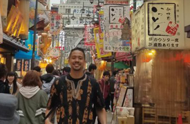 Elias, posing on a street in Japan, during his 2014 study abroad experience