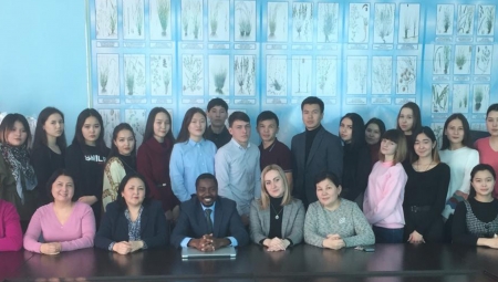 Group of US and Kazakh higher education staff seated together on a site visit in Kazakhstan