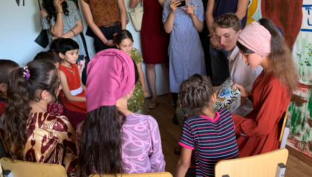 A young woman reads to children at the newly completed library. 